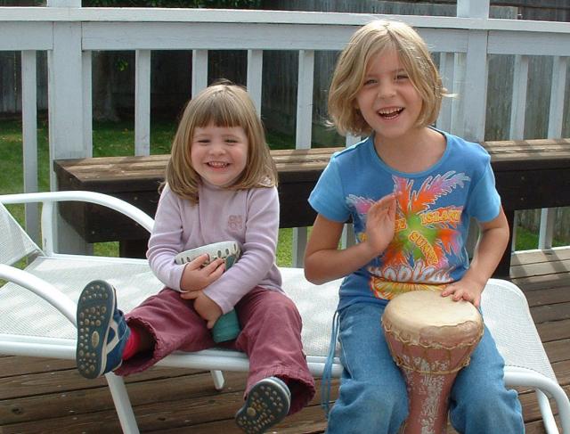 04 Amaia and Carla enjoying the drums on the deck at Grandma's house