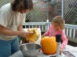 11 Kathryn helping Carla carve the pumpkin and scrape out the seeds